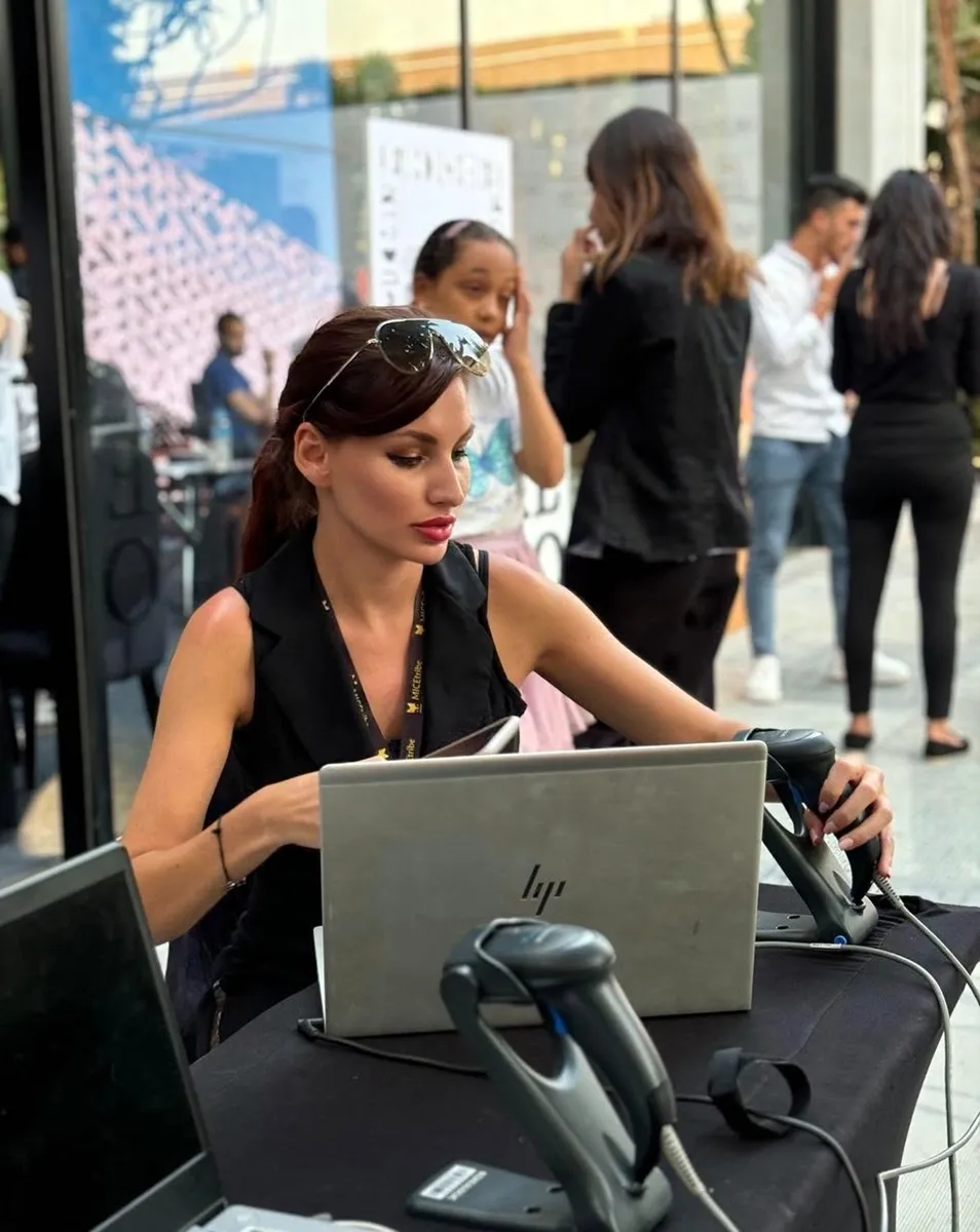 Claudia przy laptopie na stanowisku rejestracji wydarzenia